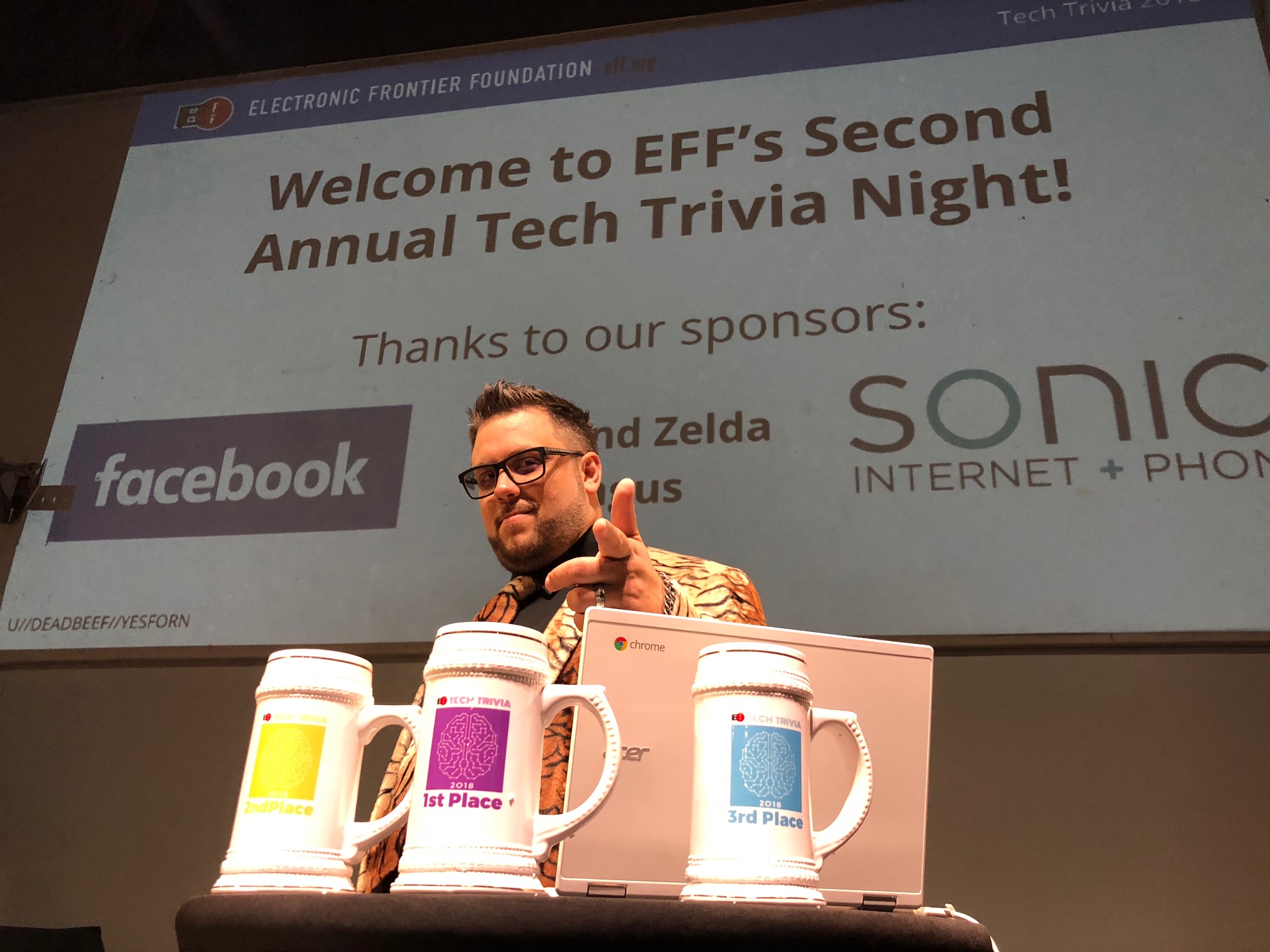 Let the Games begin! The Cybertiger, CooperQ, on-stage in front of a slide thanking our sponsors Bob and Zelda Angus, Facebook and Sonic