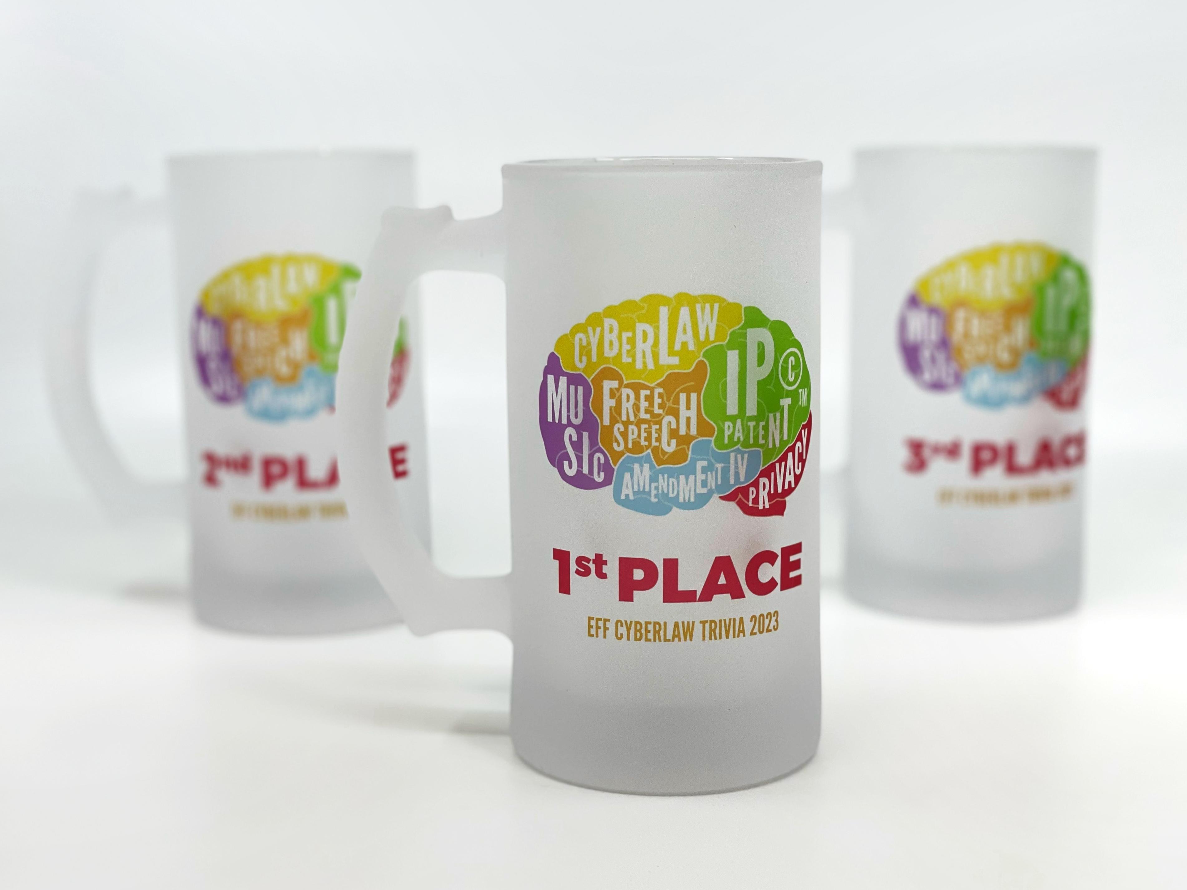 The prizes, EFF steins! Three EFF steins featuring the Cyberlaw Trivia brain logo. Front stein is first place, then second to the left, and third to the right.